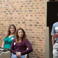 woman standing and talking to group